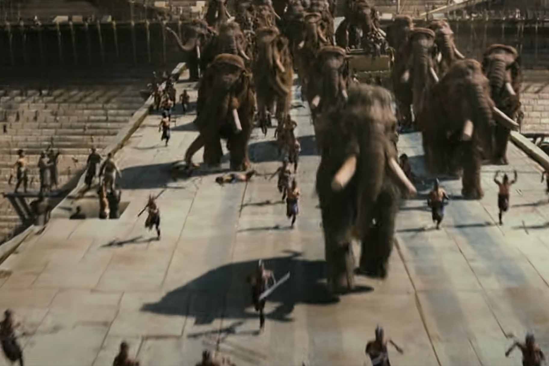 A group of elephants accompanied by humans march on a road in 10,000 BC (2008).