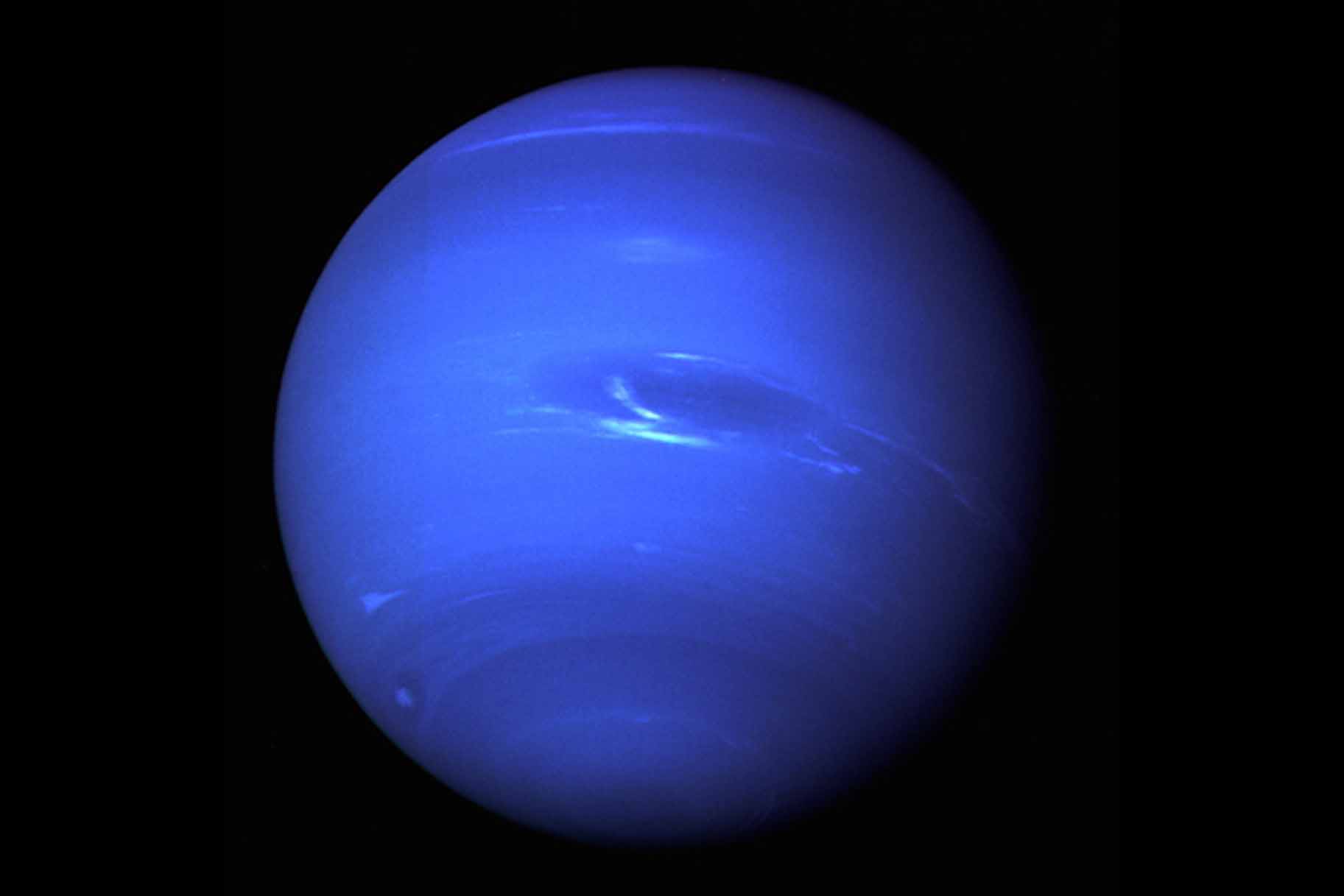 Neptune appears to glow blue.