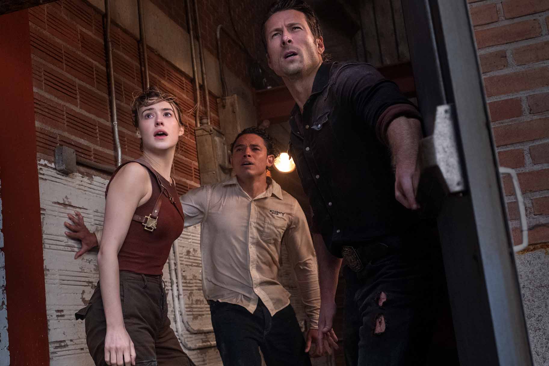 Kate (Daisy Edgar-Jones), Javi (Anthony Ramos), and Tyler (Glen Powell) appear shocked in Twisters (2024).