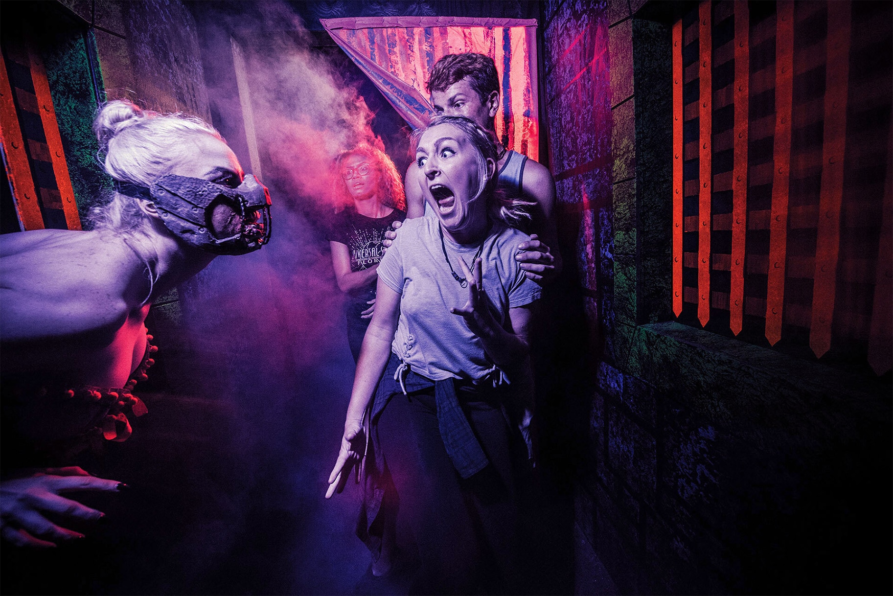 A woman screams in a haunted house during universal orlandos halloween horror nights