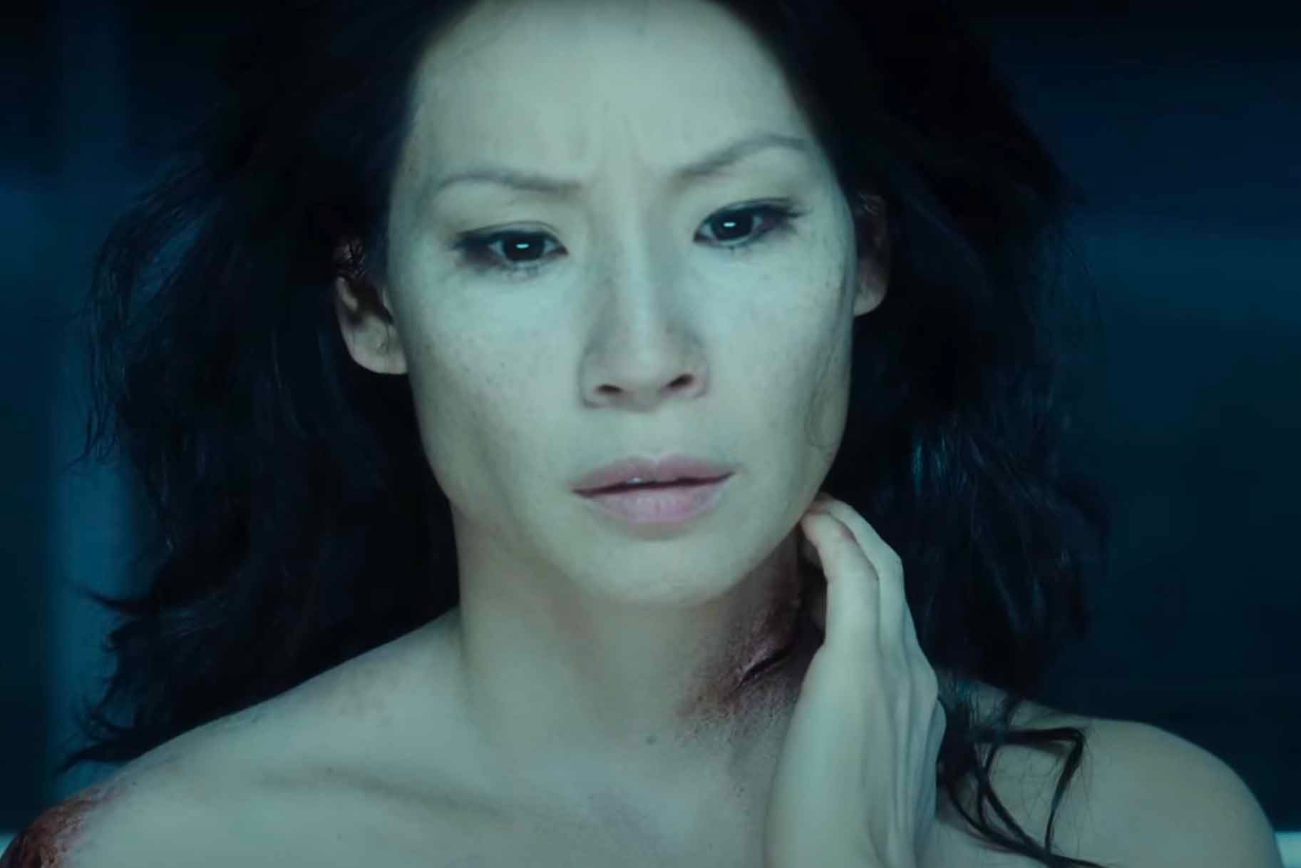 Sadie Blake (Lucy Liu) touches a gash in her neck in Rise: Blood Hunter (2007).