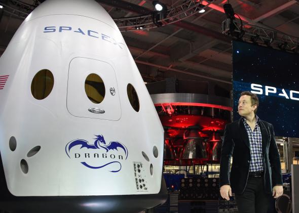 Elon Musk next to the recently unveiled SpaceX Dragon V2 capsule, designed for human flight. Credit:  Robyn Beck/AFP/Getty Images