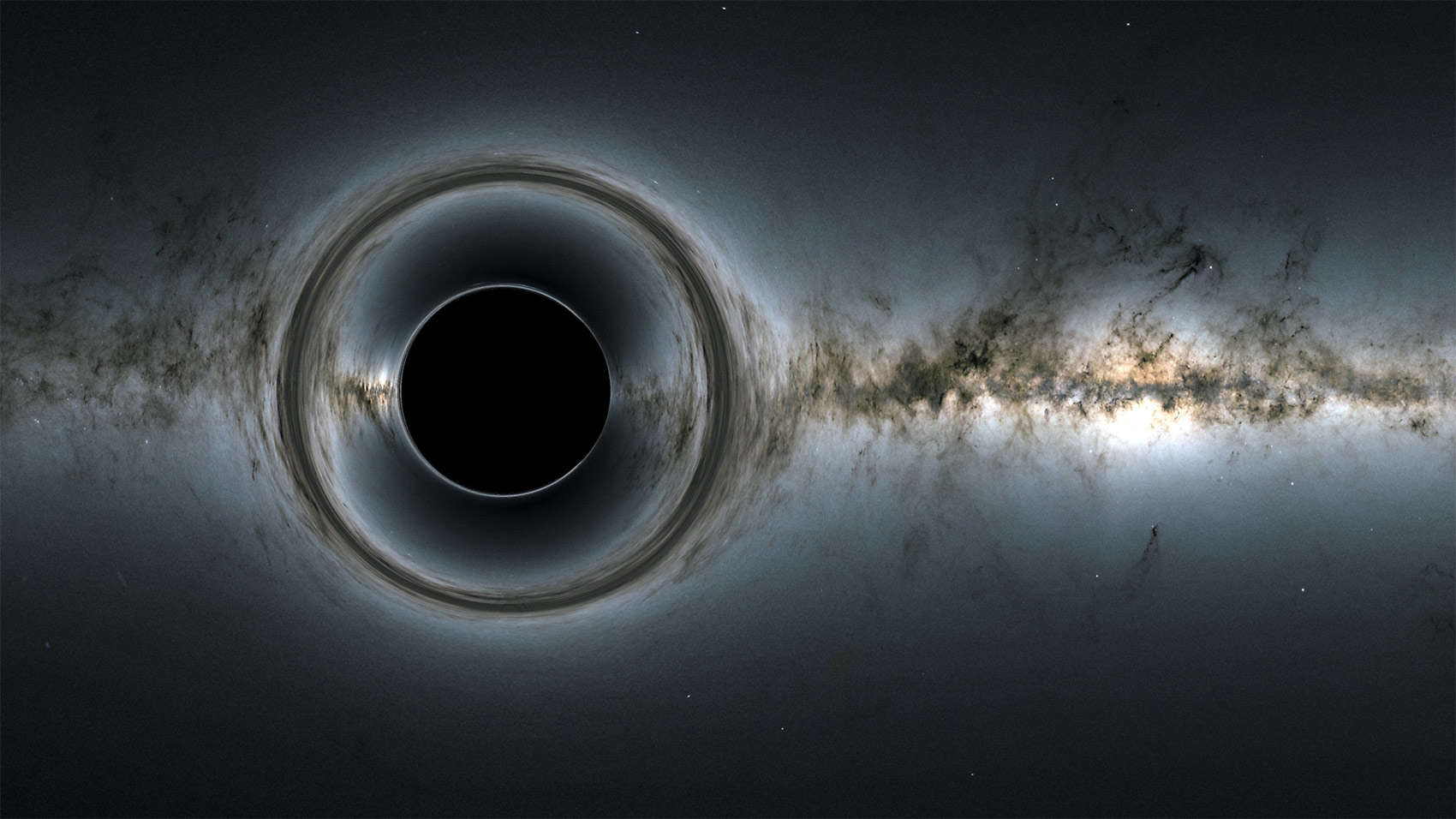 A simulated image shows what happens when a black hole’s gravity distorts the light from stars behind it. Credit: NASA