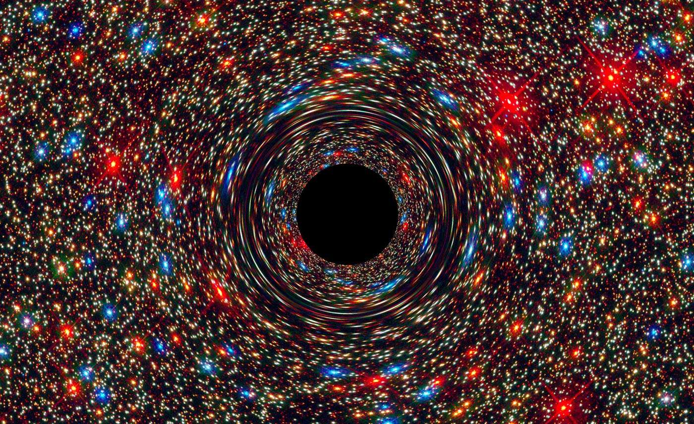 Simulation of a massive black hole distorting light from the stars behind it. Credit: NASA, ESA, and D. Coe, J. Anderson, and R. van der Marel (STScI)