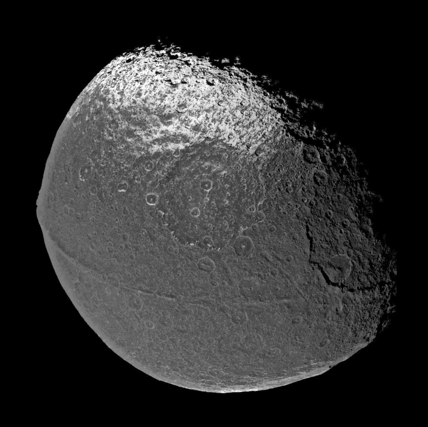 Iapetus, a moon of Saturn, has many odd features, including an immense ridge of material going around its equator. As of yet it’s still unexplained. Credit: NASA/JPL/Space Science Institute