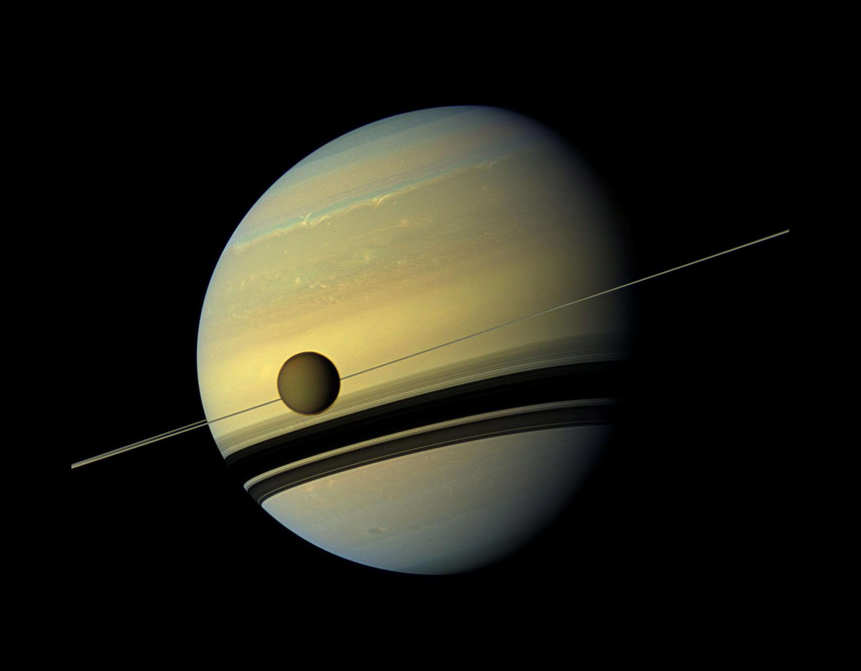 The giant moon Titan in front of Saturn's edge-on rings, seen by the Cassini spacecraft in 2012. Credit: NASA/JPL-Caltech/Space Science Institute