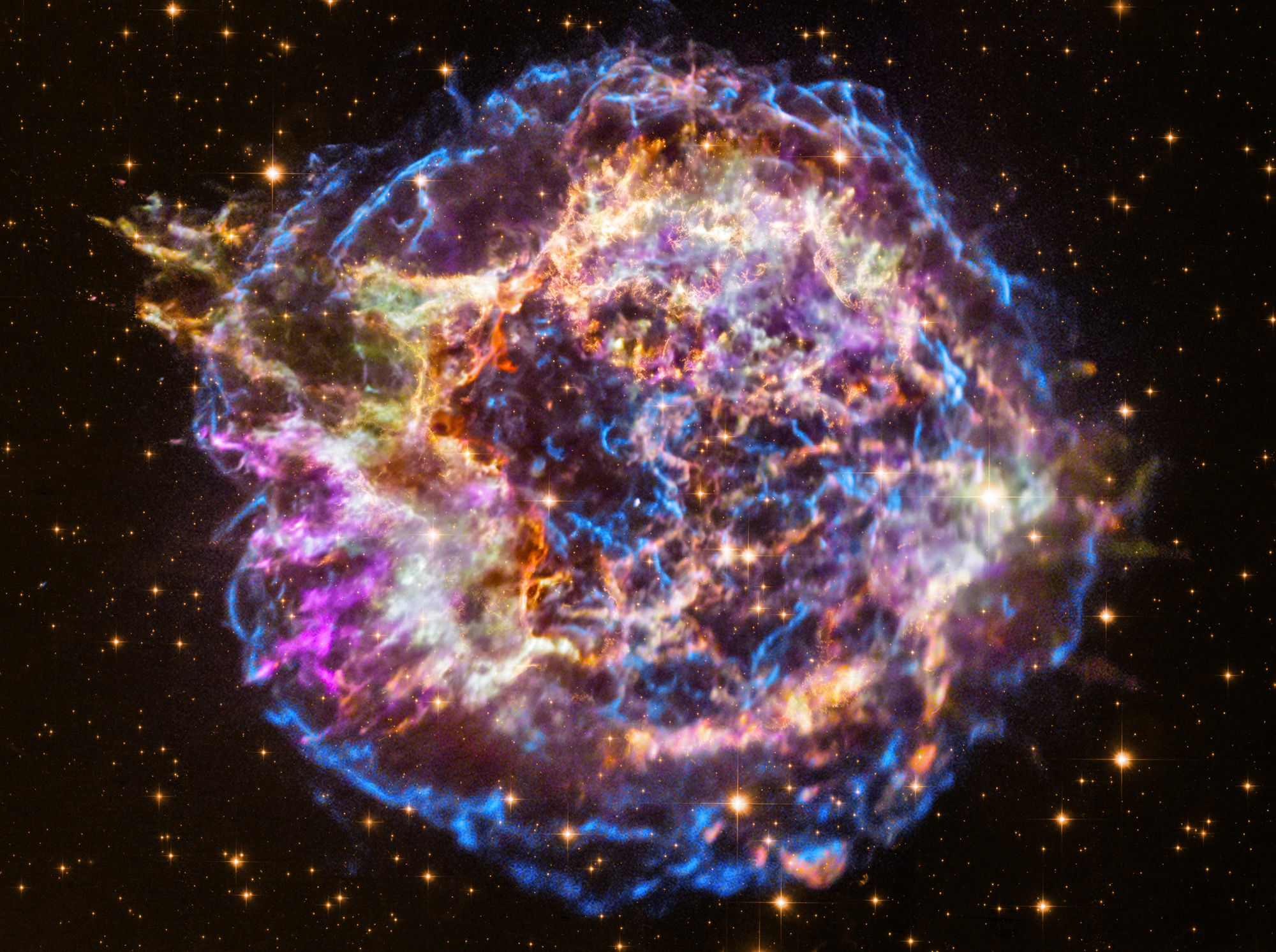 A stunning image of the supernova remnant Cas A combines visible light images from Hubble with X-ray observations by Chandra. The different colors represent different energies of the light.