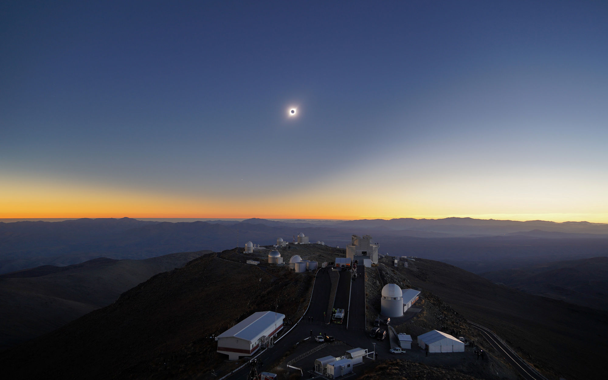 The total solar eclipse of July 2, 2019 over the ESO’s La Silla astronomical observatory in Chile. You can see the shadow of the Moon on the sky itself, a lopsided curve due to perspective. The “star” to the lower left is actually the planet Venus. 