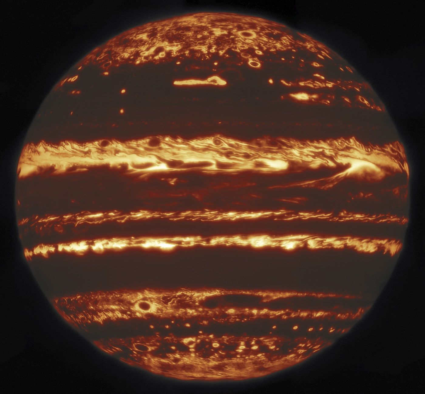 Jupiter in thermal infrared light; bright regions are clear air where heat from inside the planet can leak out, while darker regions are where clouds block that heat.