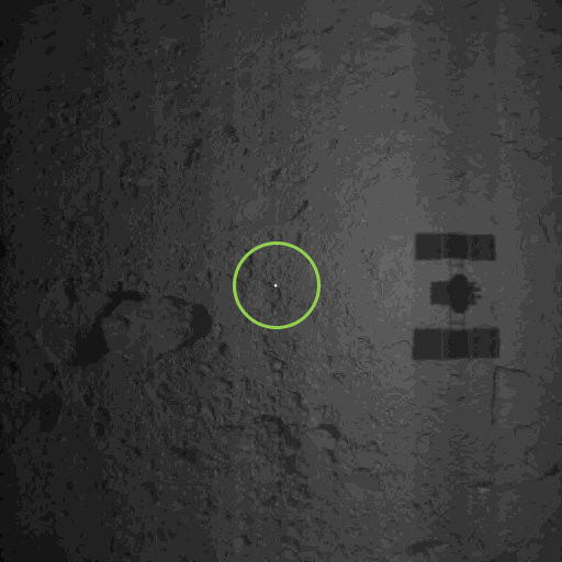 Hayabusa-2 dropped a “target marker” (bright spot inside green circle) on the surface of Ryugu to help measure the spacecraft’s motion as it approaches the asteroid’s surface. Credit: JAXA