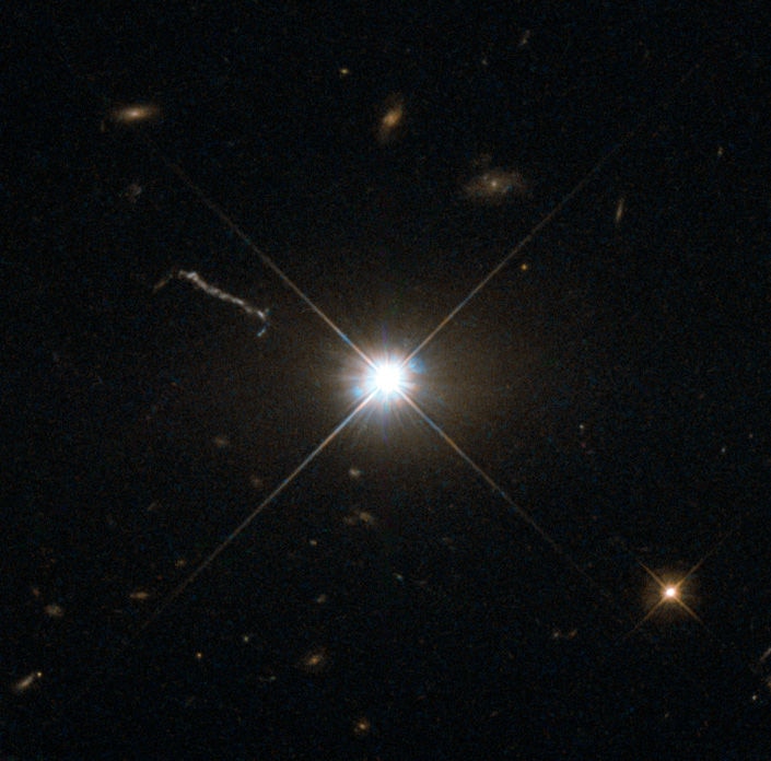 A deep Hubble image of the quasar 3C 273 shows it as a blazing point source, almost like any other star. The linear feature to the upper left is a jet of material accelerated by the quasar’s black hole central engine. Credit: ESA/Hubble & NASA