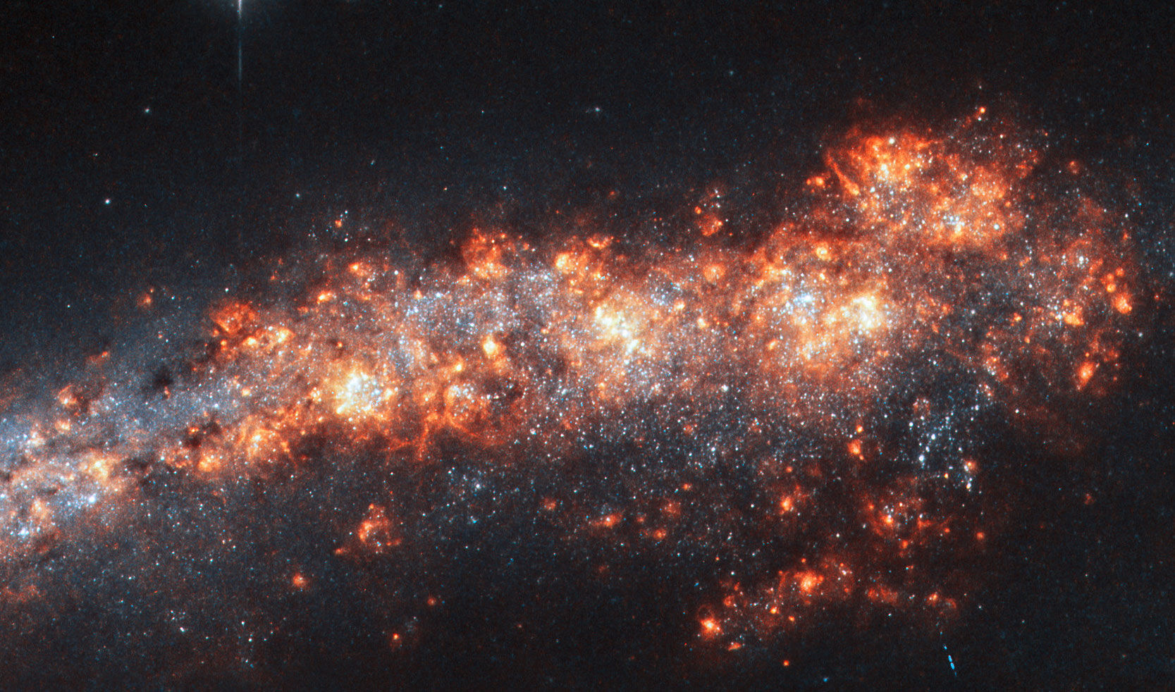 The edge-on spiral galaxy NGC 3432 shows off a lot of gas clouds in this image from Hubble Space Telescope. Credit: ESA/Hubble & NASA, A. Filippenko, R. Jansen
