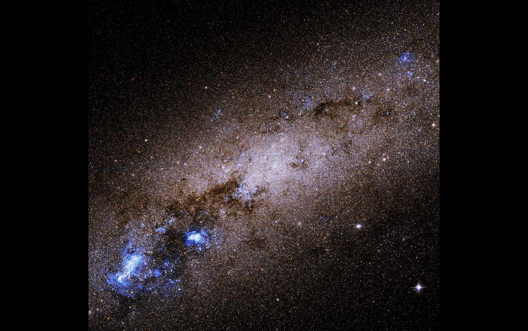 NGC 55, a nearby edge-on dwarf spiral galaxy, seen by Hubble Space Telescope. Credit: NASA, ESA, R. de Jong (Leibniz-Institut fur Astrophysik Potsdam [AIP]), and G. Illingworth (University of California – Santa Cruz)