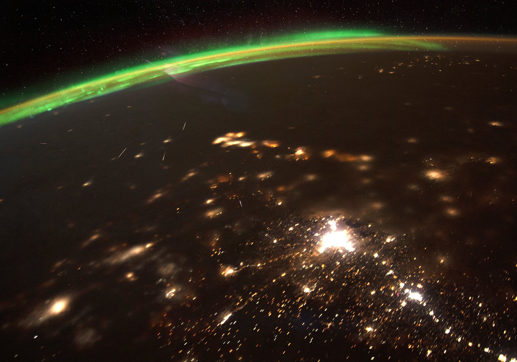 A composite photo (made up of several individual pictures) of Quadrantid meteors burning up over Earth, taken from the International Space Station on 4 January, 2020. The green glow of the aurora borealis is seen to the north. Credit: NASA