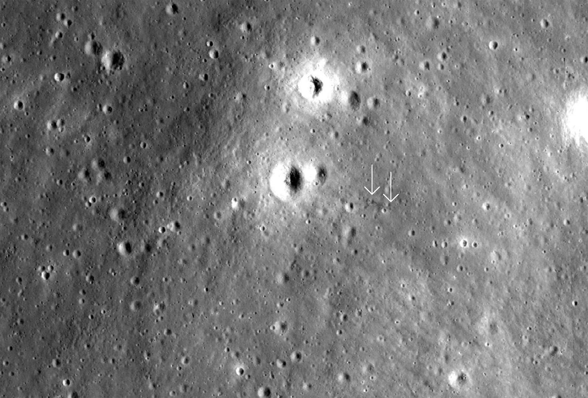 An area of the Moon where the Apollo 12 Ascent stage may have crashed, leaving a dark furrow in the surface (arrowed). Credit: NASA/GSFC/Arizona State University / Quickmap