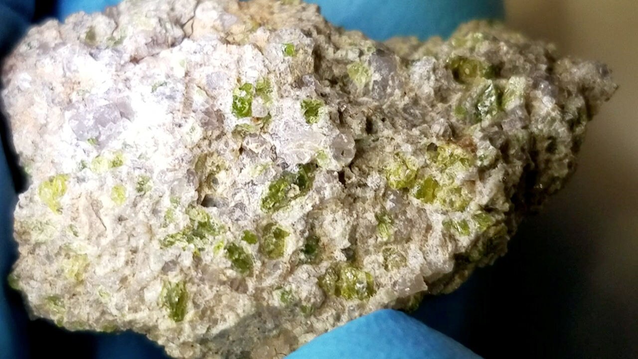 A close-up of NWA 11119 shows the lovely green crystals of pyroxene. Credit: UNM Institute of Meteoritics