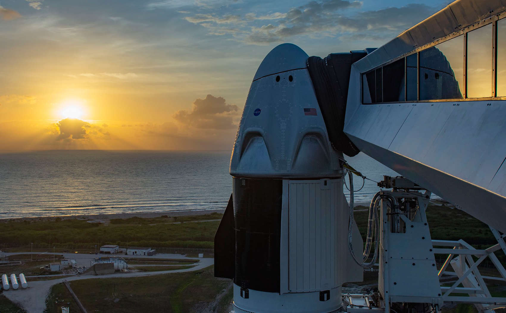 The Sun rises on the Crew Dragon atop a Falcon 9 in the shortly before the Demo-2 launch, returning American astronauts to space from American soil. Credit: SpaceX