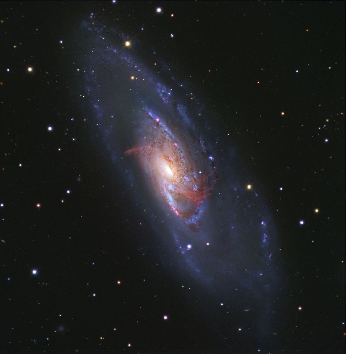 The galaxy M 106, in observations taken by Hubble Space Telescope combined with two smaller (but wider field of view) telescopes. The inner red arms arenât actually spiral arms, but gas heated by a supermassive black hole.
