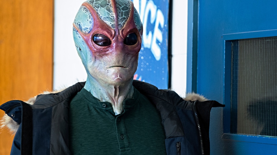 Alien Harry (Alan Tudyk) stands in Resident Alien Episode 305.