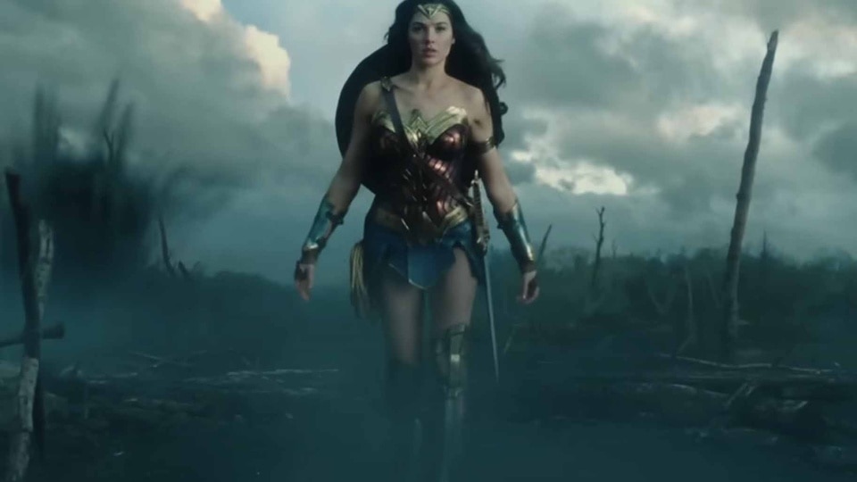 Wonder Woman (Gal Gadot) walks through a battlefield in Wonder Woman (2017).