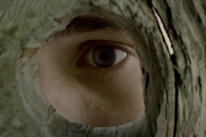 An eye peers through a fence in The Stand at CBS All Access