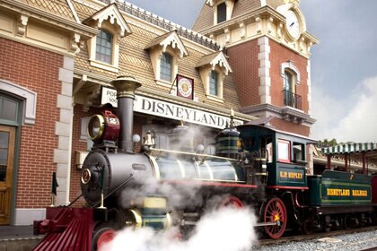 Disneyland steam train in front of a Disneyland sign