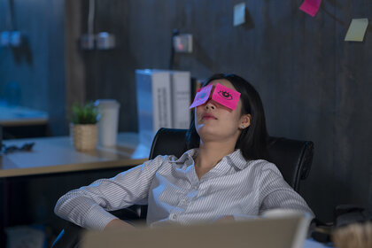 Young woman asleep in office.