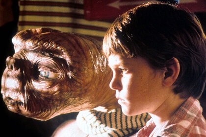 ET looking out window with Henry Thomas in a scene from the film 'E.T. The Extra-Terrestrial', 1982.