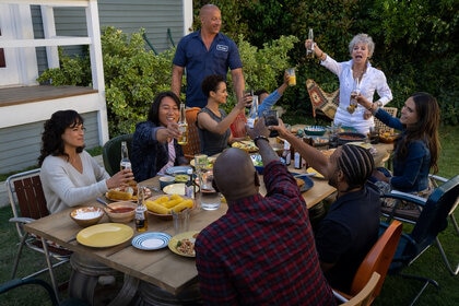 clockwise, from left) Letty (Michelle Rodriguez), Han (Sung Kang), Ramsey (Nathalie Emmanuel), Dom (Vin Diesel), Little Brian (Leo Abelo Perry), Abuelita (Rita Moreno), Mia (Jordana Brewster), Tej (Chris ‘Ludacris’ Bridges, back to camera) and Roman (Tyrese Gibson, back to camera) in Fast X (2023)