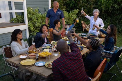 (clockwise, from left) Letty (Michelle Rodriguez), Han (Sung Kang), Ramsey (Nathalie Emmanuel), Dom (Vin Diesel), Little Brian (Leo Abelo Perry), Abuelita (Rita Moreno), Mia (Jordana Brewster), Tej (Chris ‘Ludacris’ Bridges, back to camera) and Roman (Tyrese Gibson, back to camera) in Fast X (2023)