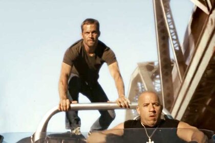 Paul Walker and Vin Diesel perform stunts in a car in Fast Five