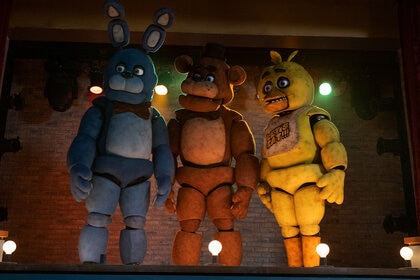 A bunny, bear, and duck animatronic standing together in Five Night's at Freddy's (2023)