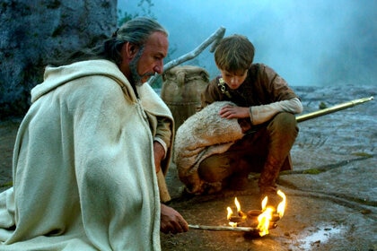 Ben Kingsley and Thomas Sangster around a fire in The Last Legion (2007)