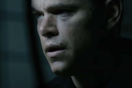 Matt Damon peers out a window in The Bourne Ultimatum (2007)