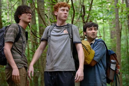 Martin Herlihy, Ben Marshall, and John Higgins backpack in a forest in Please Don't Destroy: The Treasure of Foggy Mountain (2023)