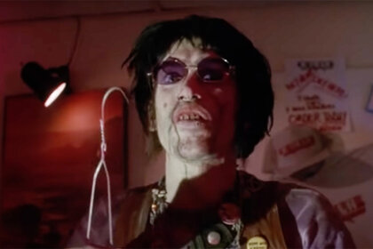 Chop-Top (Bill Moseley) holds a hanger in The Texas Chainsaw Massacre 2 (1986)