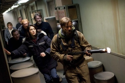 The cast of The Thing runs down a hallway in The Thing (2011).