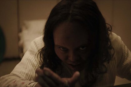 A posssessed Angela Fielding (Lidya Jewett) holds a hand out in The Exorcist: Believer (2023)