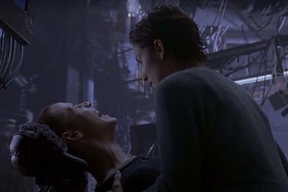 Trinity (Carrie-Anne Moss) watches Neo (Keanu Reeves) scream in pain in The Matrix (1999)