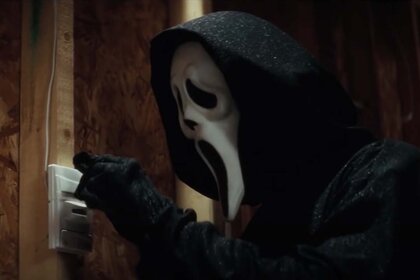 Ghostface (Roger Jackson) flips a light switch in Scream 4 (2011).