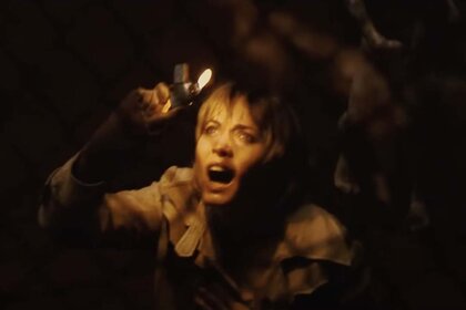 Rose (Radha Mitchell) illuminates the appalled look on her face with a lighter in in Silent Hill (2006).