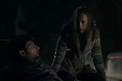 Tom (Adam Scott) and Sarah Engel (Toni Collette) give a haunting look to each other in the dark in Krampus (2015).