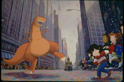 Rex (John Goodman) dances in the streets as people cheer in We're Back! A Dinosaur's Story (1993).