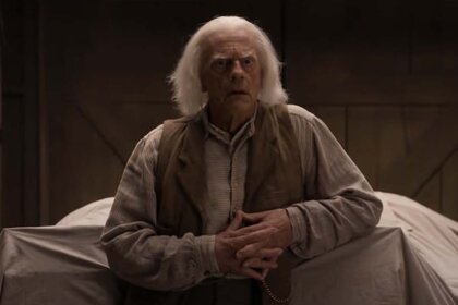 Dr. Emmett Brown (Christopher Lloyd) wears a beige shirt with a brown vest in A Million Ways to Die in the West (2014).