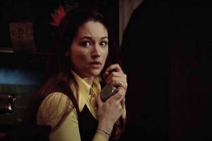 Jess Bradford (Olivia Hussey) looks fearful while gripping a phone in Black Christmas (1974).