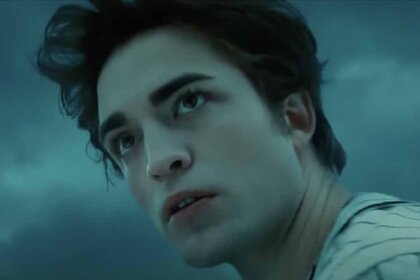 Edward Cullen (Robert Pattinson) appears with a cloudy grey sky behind him in Twilight (2008).