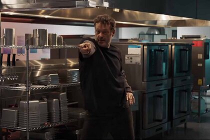 The Blissfield Butcher (Vince Vaughn) points his finger and dances in a school kitchen in Freaky (2020).
