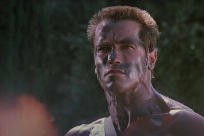 John Matrix (Arnold Schwarzenegger) appears shirtless in warpaint in Commando (1985).