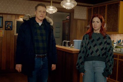 iHarry Vanderspeigle and D'Arcy Bloom stand in a kitchen in Resident Alien Episode 301.