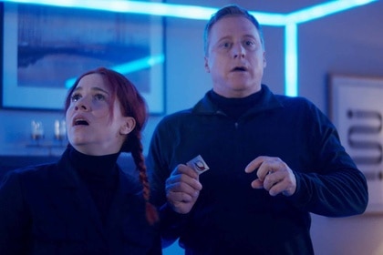 D'Arcy Bloom and Harry Vanderspeigle appears shocked in a glowing blue cube in Resident Alien Episode 302.